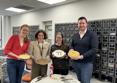 A picture of Henninger and Armbruster lab members who volunteered to make pies for pi day.